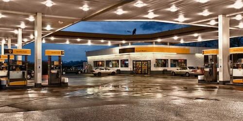 An HDR image of a generic gas station and convenience store at dusk immediately after a big rain.